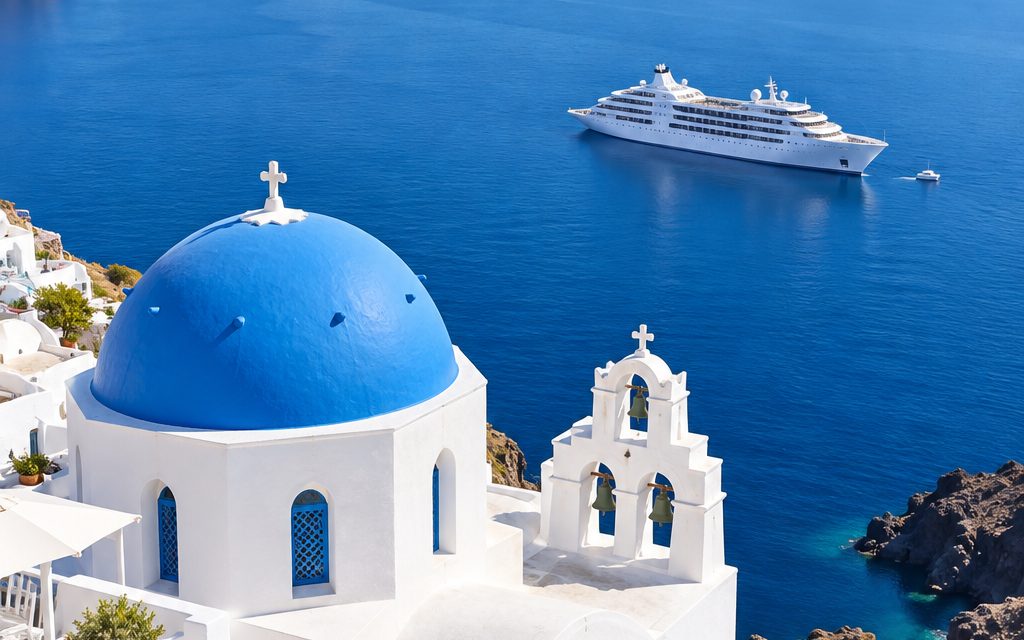 A blue-domed chapel above the Santorini caldera with a small cruise ship at anchor